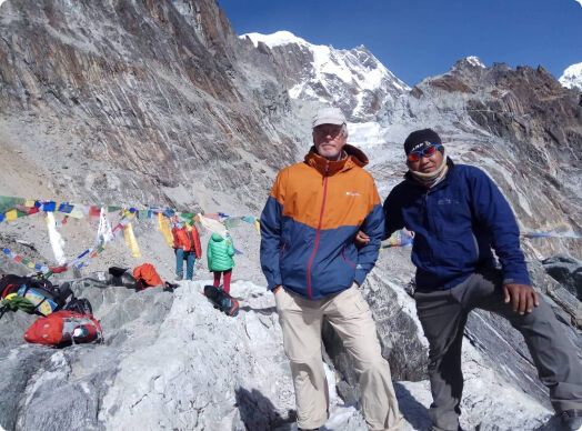 Climber and a Sherpa standing on a mountain
